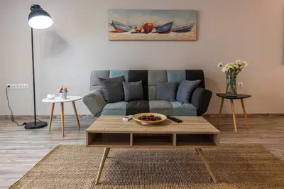 a living room with a couch and a coffee table at Athenian boutique apartments in Athens