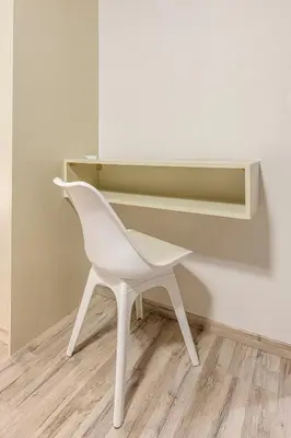 a white chair sitting in front of a desk at Athenian boutique apartments in Athens