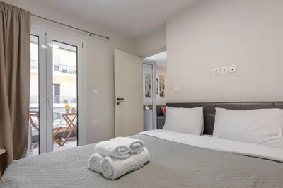 a bedroom with a bed with towels on it at Athenian boutique apartments in Athens