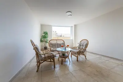 a room with a table and chairs and a window at Athenian boutique apartments in Athens