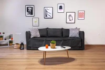 a living room with a black couch and a table at Athenian boutique apartments in Athens