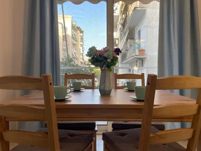 a wooden table with a vase of flowers on it at Traveller's Choice Attiki in Athens