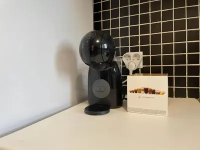 a black robot sitting on a counter next to a box at Traveller's Choice Attiki in Athens