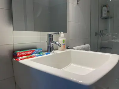 a white sink in a bathroom with a mirror at Traveller's Choice Attiki in Athens