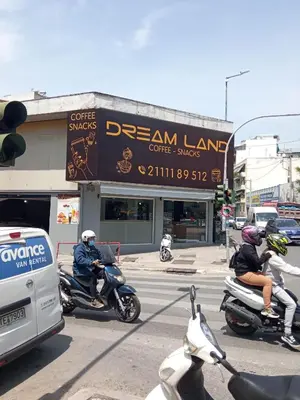 a group of people riding motorcycles on a city street at Traveller's Choice Attiki in Athens