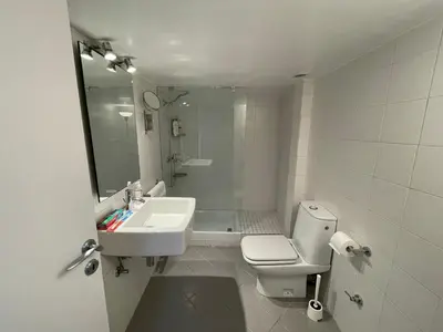 a white bathroom with a sink and a toilet at Traveller's Choice Attiki in Athens