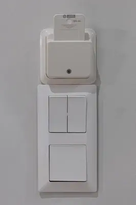 a white cell phone is on a white adapter at Feel like home in Athens