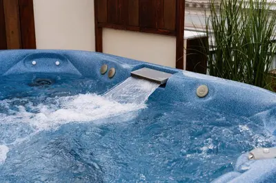 a blue hot tub with a water fall at Visum Acropol ,3BR - Private Terrace-Jacuzzi - Amazing View in Athens