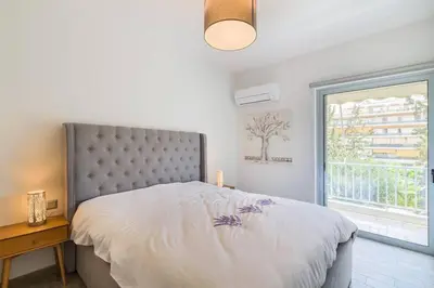 a bedroom with a large bed and a window at stylish zografou apartement in Athens