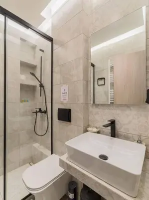 a bathroom with a toilet and a sink and a shower at stylish zografou apartement in Athens