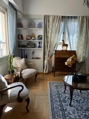 a living room with a chair and a table at 2 BD Apt in Syntagma with Acropolis view in Athens
