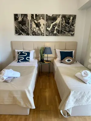 two beds sitting next to each other in a room at 2 BD Apt in Syntagma with Acropolis view in Athens