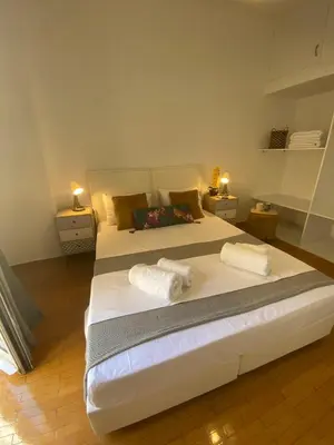 a bedroom with two beds with towels on them at 2 BD Apt in Koukaki 8’ away from Acropolis in Athens