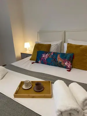 two beds with a tray with two cups and towels at 2 BD Apt in Koukaki 8’ away from Acropolis in Athens