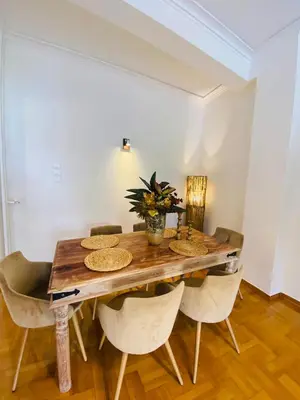 a dining room with a wooden table and chairs at 2 BD Apt in Koukaki 8’ away from Acropolis in Athens
