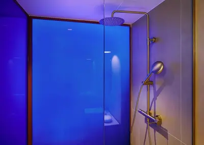 a glass shower door with a lamp in a room at LOOM ATHENS in Athens