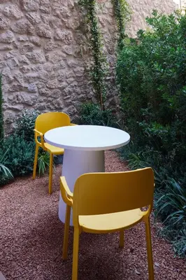 two yellow chairs and a white table and chairs at LOOM ATHENS in Athens