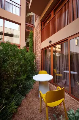 a table and two chairs in front of a building at LOOM ATHENS in Athens
