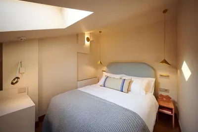 a bedroom with a large bed with a blue headboard at LOOM ATHENS in Athens