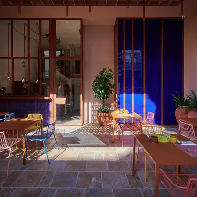 a patio with tables and chairs and a pool at LOOM ATHENS in Athens