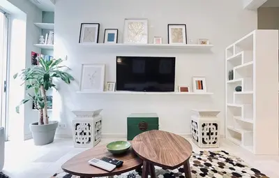 a living room with a table and a tv at James - 2BR in the Heart of Ancient Athens in Athens