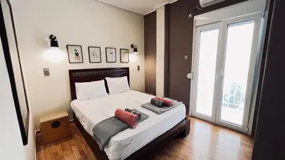 a bedroom with a bed with two pillows on it at James - 2BR in the Heart of Ancient Athens in Athens