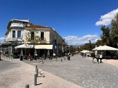 a group of people walking down a street at James - 2BR in the Heart of Ancient Athens in Athens