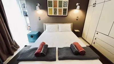 a bedroom with a bed with two pillows on it at James - 2BR in the Heart of Ancient Athens in Athens