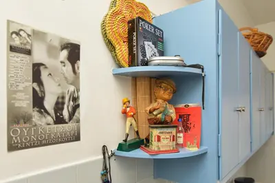 a shelf with a toy figure on a wall at Athens Stylish apt next to the beach and port in Athens