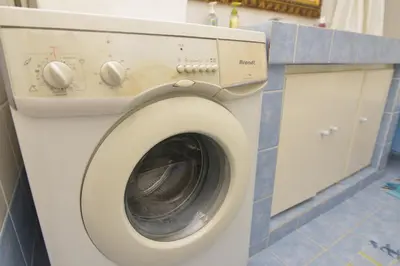 a washing machine in a bathroom with a counter at Athens Stylish apt next to the beach and port in Athens