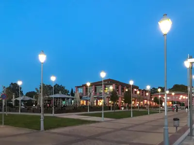 a group of street lights in front of a building at Athens Stylish apt next to the beach and port in Athens