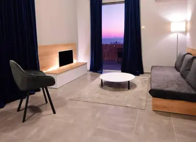 a living room with a couch and a table at Athens Riviera Modern Penthouse with Sea View in Athens