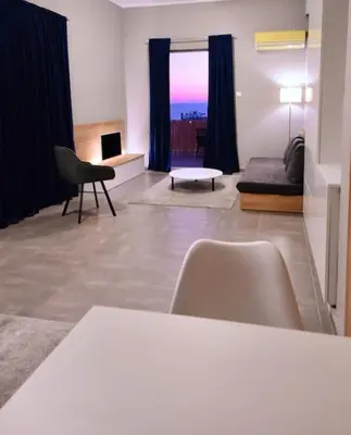 a living room with a couch and a table at Athens Riviera Modern Penthouse with Sea View in Athens