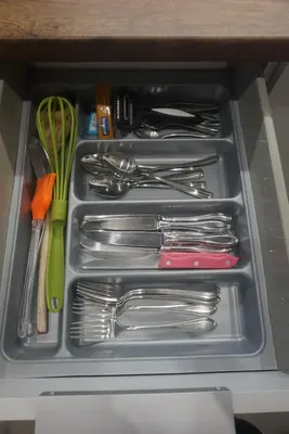 a drawer filled with silver utensils in a cabinet at Vasili's and Vasiliki's luxury apartment in Athens
