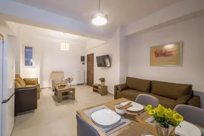 a living room with a couch and a table at SOKOS Residence, 3' walk from Neos Kosmos Metro in Athens
