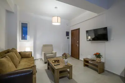 a living room with a couch and a table at SOKOS Residence, 3' walk from Neos Kosmos Metro in Athens