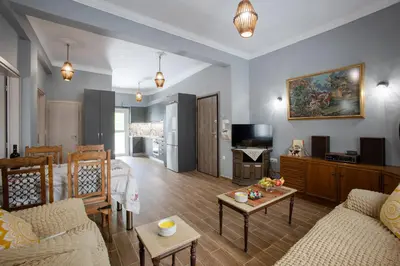 a living room with a couch and a table at Danaï house in Athens