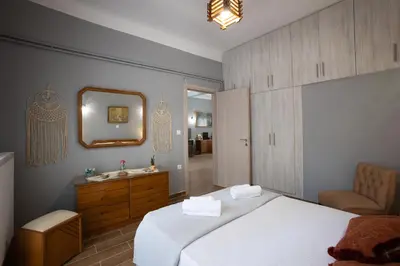 a bedroom with a bed and a sink and a mirror at Danaï house in Athens