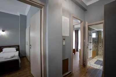 a bedroom with a bed and a door leading to a hallway at Danaï house in Athens
