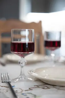 two glasses of red wine sitting on a table at Danaï house in Athens
