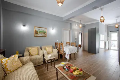 a living room with a couch and a table at Danaï house in Athens