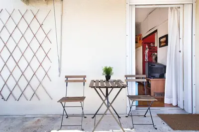 a table and two chairs in front of a door at Rooftop Athens Central Studio in Athens