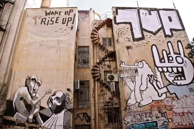 a building with graffiti on the side of it at Rooftop Athens Central Studio in Athens