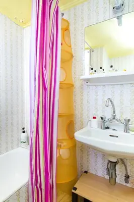 a bathroom with a sink and a shower curtain at Rooftop Athens Central Studio in Athens