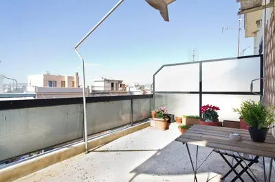 a patio with a wooden bench on a balcony at Rooftop Athens Central Studio in Athens