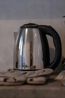 a tea kettle sitting on top of a table at SOKOS Residence, 1' walk from Aghios Ioannis Metro in Athens