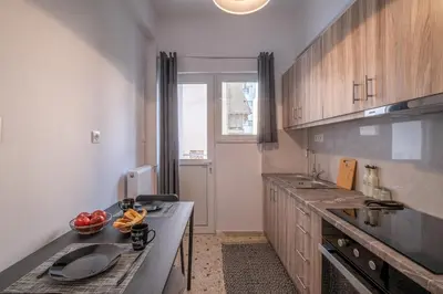 a kitchen with a sink and a counter top at SOKOS Residence, 1' walk from Aghios Ioannis Metro in Athens