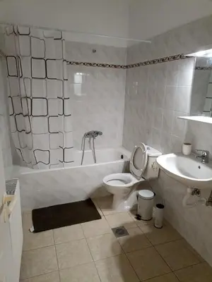 a bathroom with a tub and a toilet and a sink at Airport city center 2 in Spáta