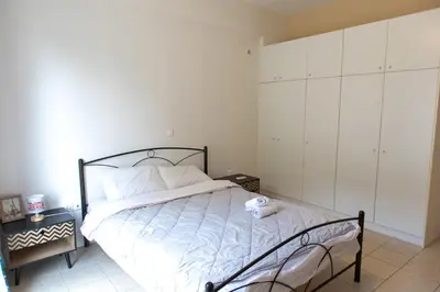 a bedroom with a large bed with a white bedspread at Airport city center 2 in Spáta