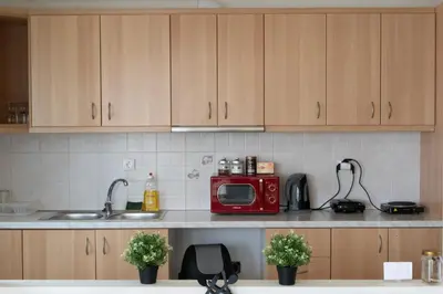 a kitchen with a red microwave on a counter at Airport city center 2 in Spáta